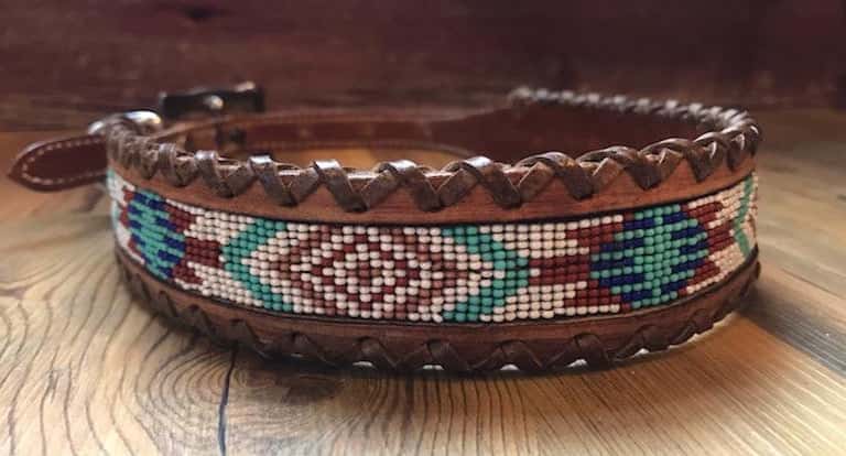 Genuine leather dog collar with white, teal, and burgundy navajo beaded inlay designa leather wrapped edge and copper hardware.