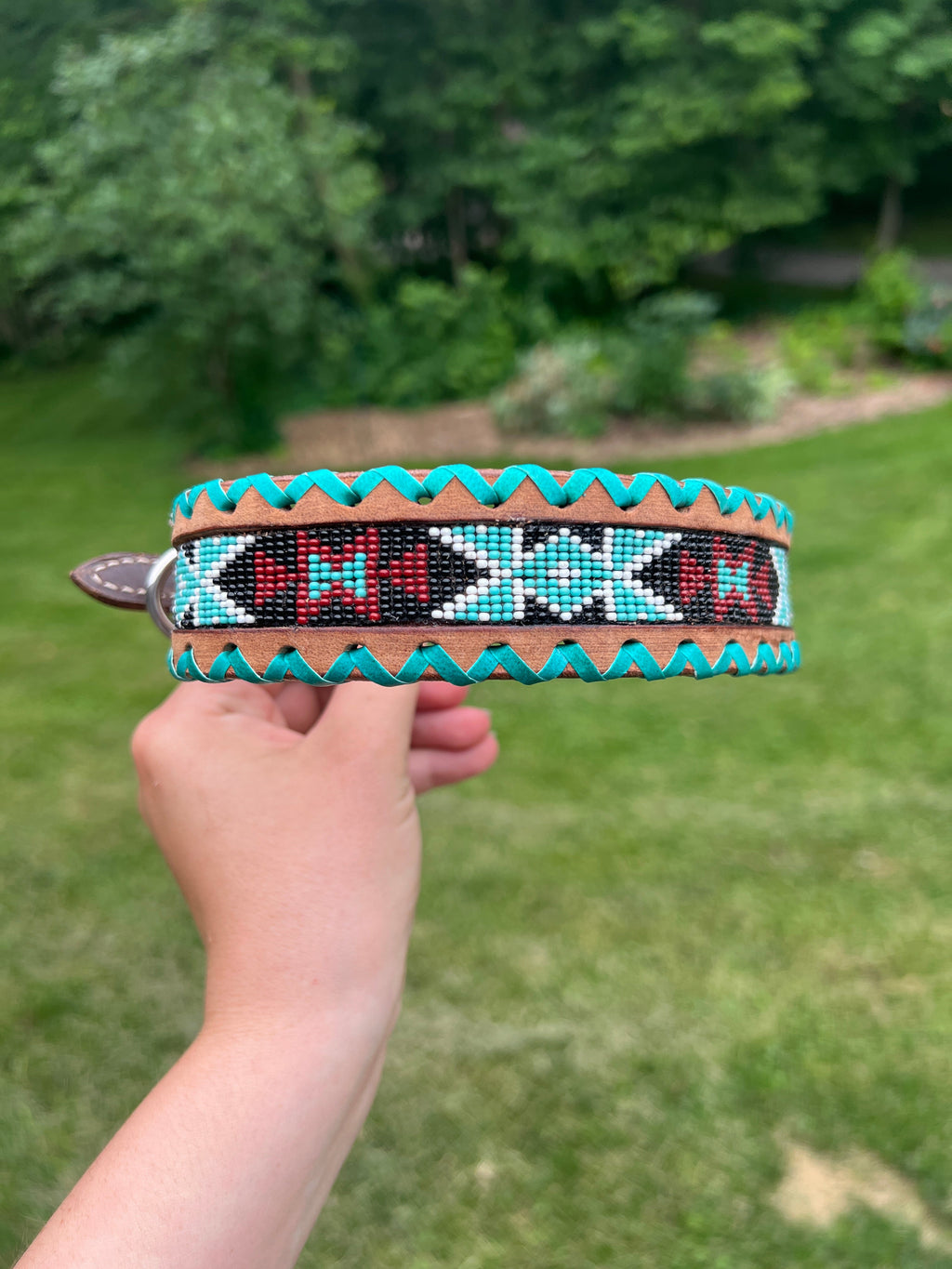 Genuine leather dog collar with teal, white, and burgundy  beaded inlay design, a rawhide wrapped edge