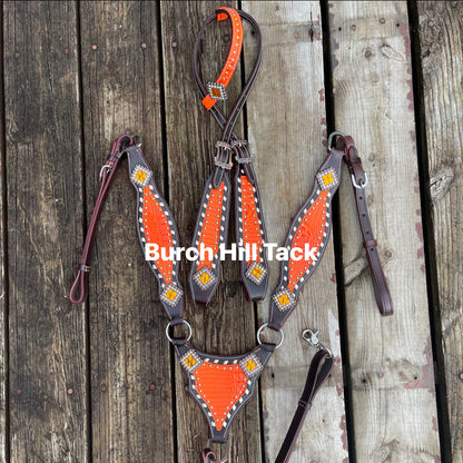 Dark brown tack set with vibrant orange accent