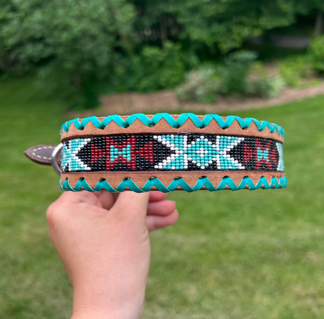 Genuine leather dog collar with teal, white, and burgundy  beaded inlay design, a rawhide wrapped edge