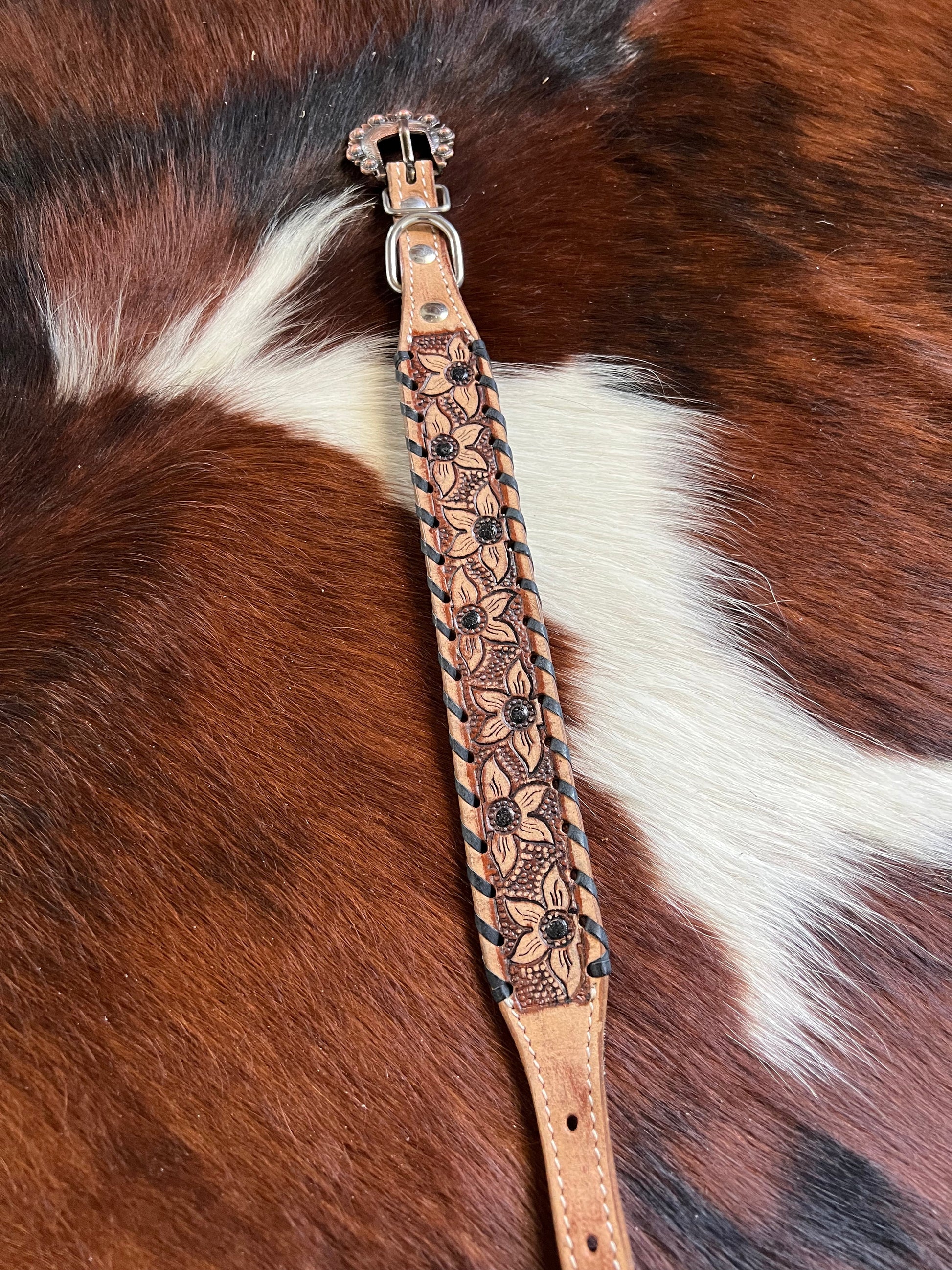 Genuine leather dog collar with black rawhide.